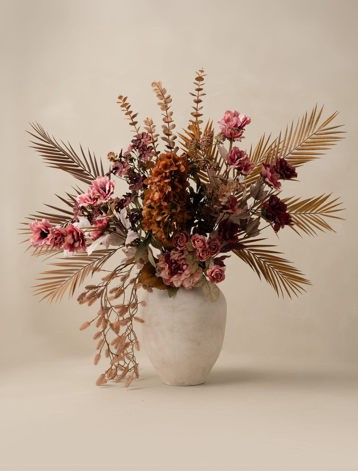 Faux palm leaf and hydrangea arrangement