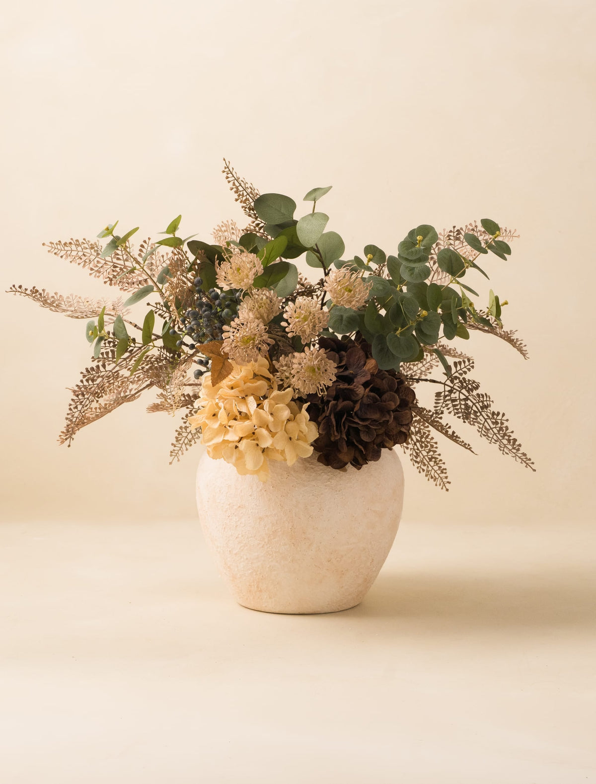 Faux fern and cream hydrangea arrangement