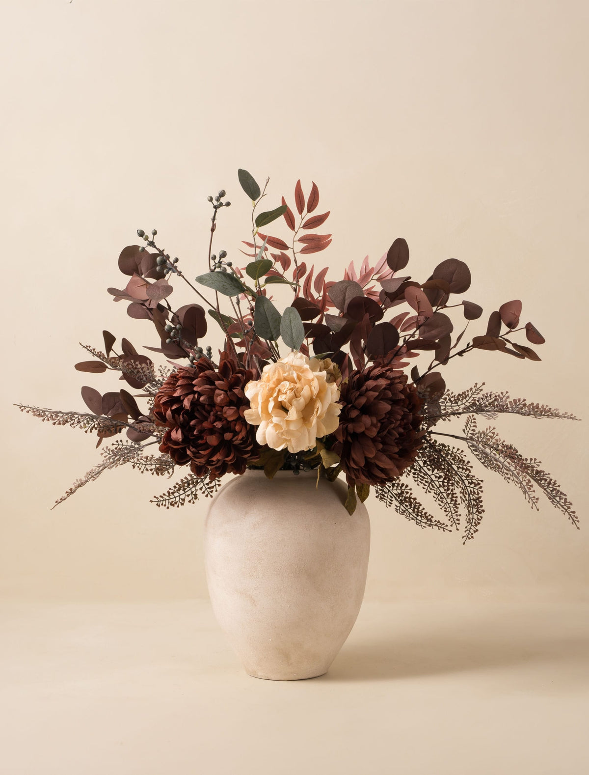 Faux dahlia and peony arrangement in a stone vase